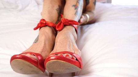 TIRED FEET IN RED SANDALS