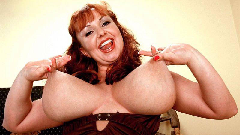 Cherry looks at the lens while playing with her big tits and natural skin.